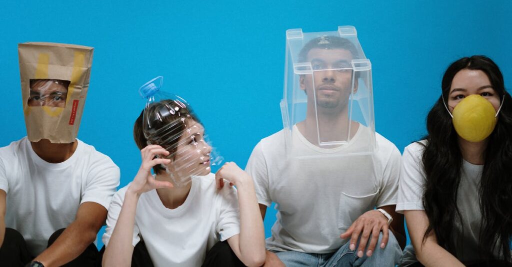 Four people wearing humorous DIY face masks against a blue background, showcasing creativity and humor.