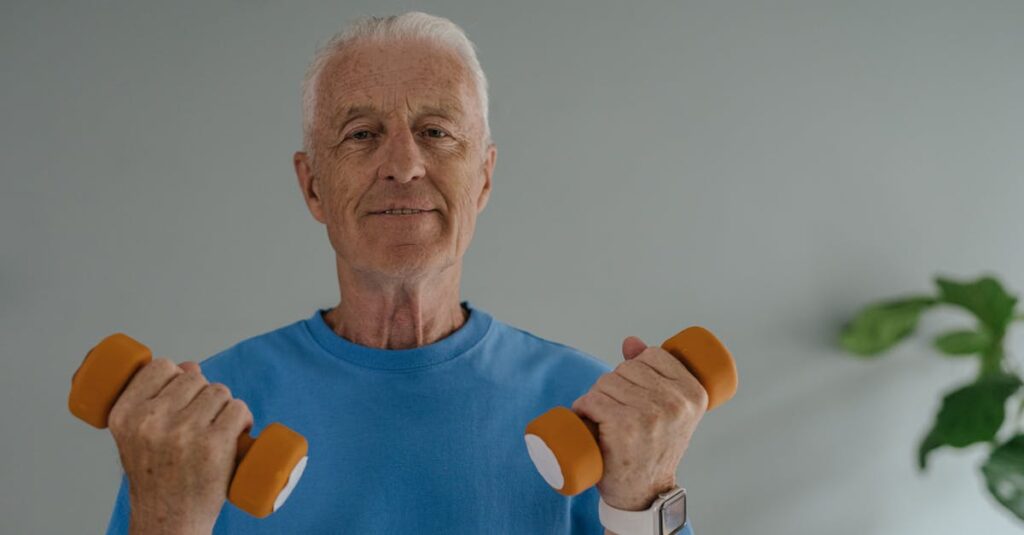 Elderly man in blue shirt lifting dumbbells and smiling indoors, promoting active lifestyle.
