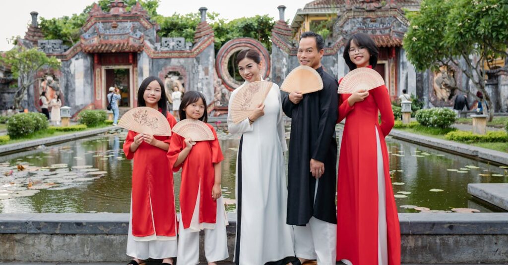 Vietnamese family in traditional attire posing at historic Hội An temple.