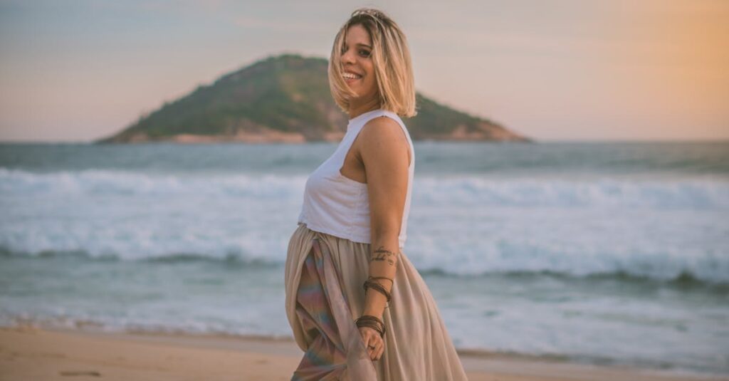 Expecting mother enjoying a serene walk on the beach at sunrise.
