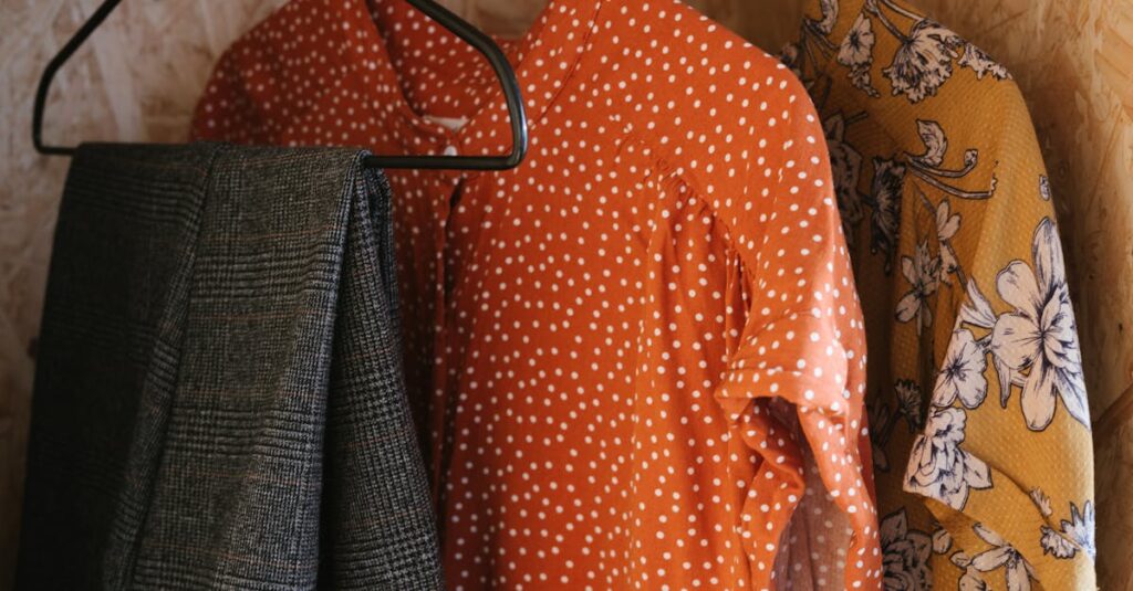 Vibrant clothes hanging on metal hangers showcasing diverse patterns and styles.