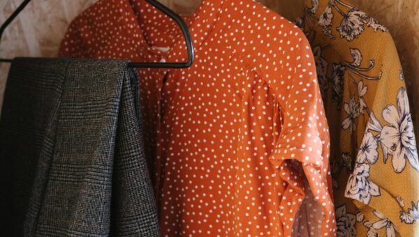 Vibrant clothes hanging on metal hangers showcasing diverse patterns and styles.