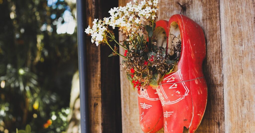 Creative floral arrangement using wooden shoes as planters on a rustic wall.