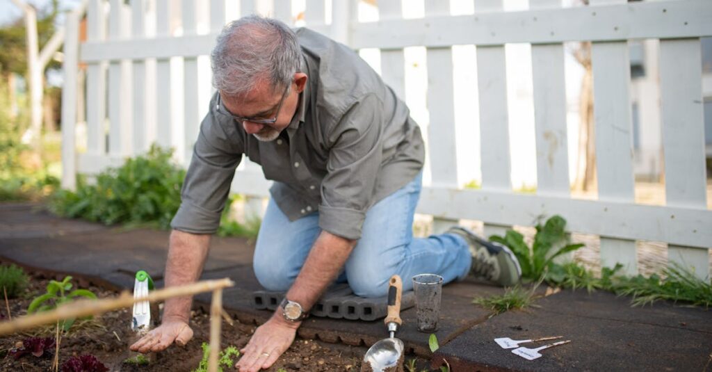 Elderly man gardening in a sunny backyard, surrounded by plants and tools.