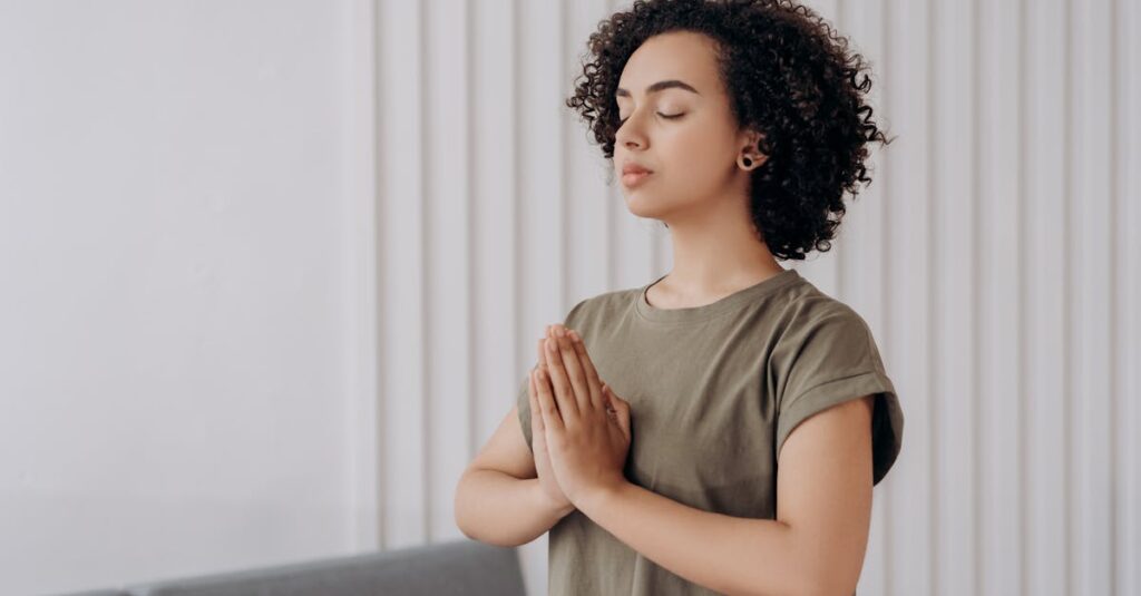 Young woman meditating indoors, practicing mindfulness and relaxation. Peaceful and serene atmosphere.