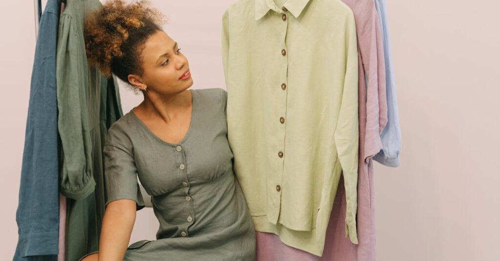 Woman in a boutique admiring beautiful linen clothes on hangers.