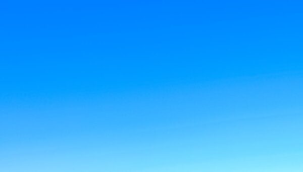 A serene view of a vibrant clear blue sky with a subtle gradient, perfect for backgrounds.