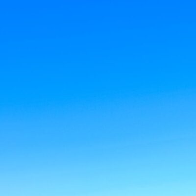 A serene view of a vibrant clear blue sky with a subtle gradient, perfect for backgrounds.