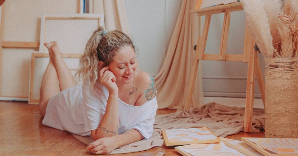Smiling woman relaxing and creating art in a cozy room with canvases and paints.