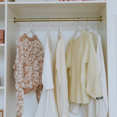 Neat closet showcasing white and pink clothes and accessories for a chic, clean look.