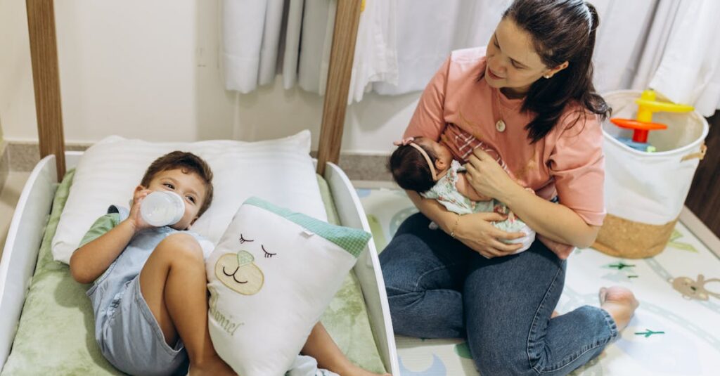 Mother with baby and young child in a warm, nurturing nursery environment.