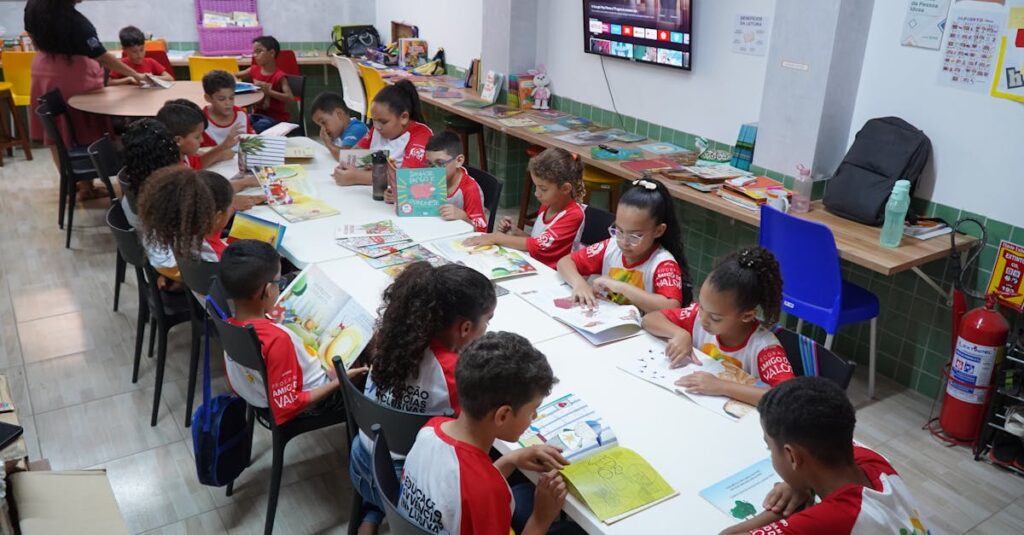 Children engaged in reading at a community library in Glória do Goitá, Brazil.