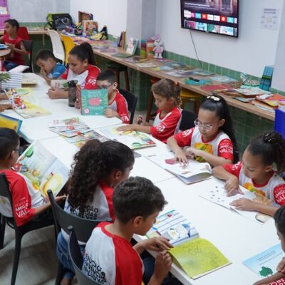 Children engaged in reading at a community library in Glória do Goitá, Brazil.