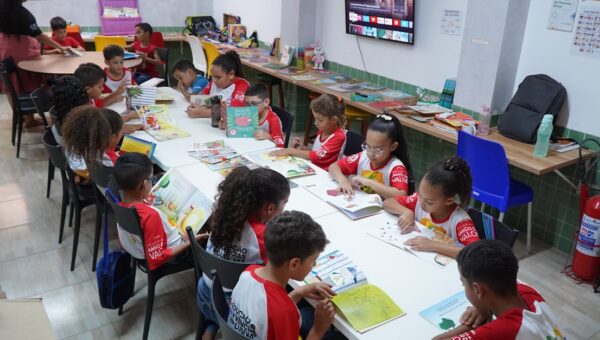Children engaged in reading at a community library in Glória do Goitá, Brazil.