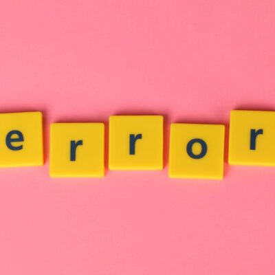 Yellow block letters spelling 'error' on a vibrant pink background, capturing a playful message.