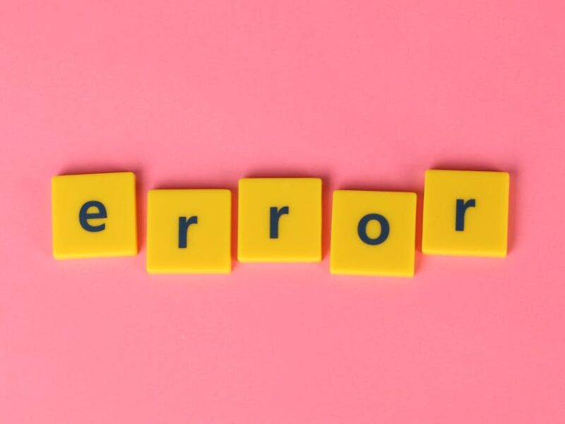 Yellow block letters spelling 'error' on a vibrant pink background, capturing a playful message.