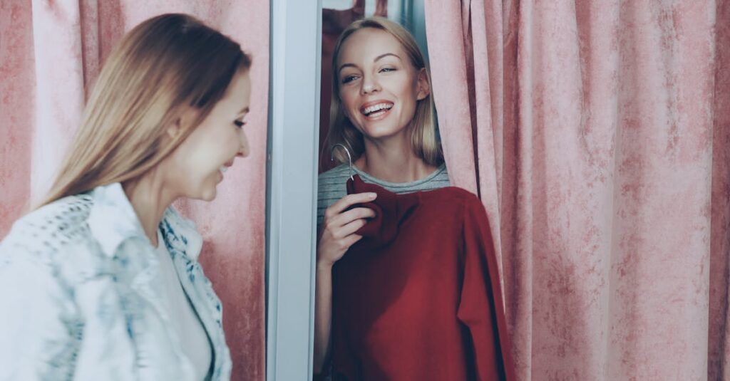 Two women enjoying a shopping experience, smiling in a changing room.