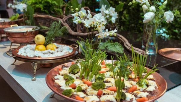 Beautifully presented gourmet dishes garnished with fresh herbs and vegetables, creating a vibrant and inviting display.