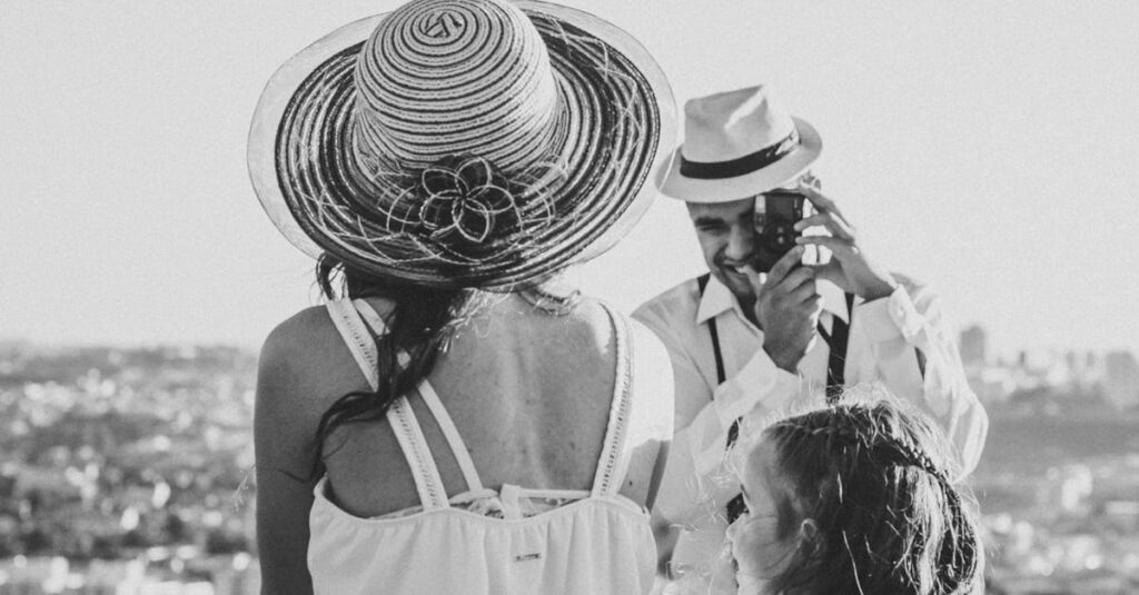 A black and white family portrait of a couple and child overlooking Sorocaba, Brazil on a sunny day.