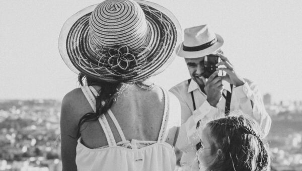 A black and white family portrait of a couple and child overlooking Sorocaba, Brazil on a sunny day.