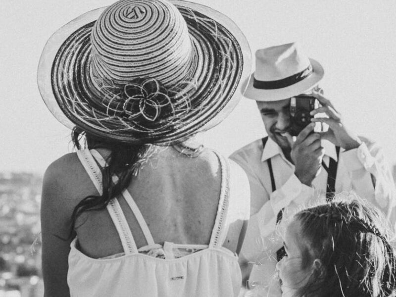 A black and white family portrait of a couple and child overlooking Sorocaba, Brazil on a sunny day.