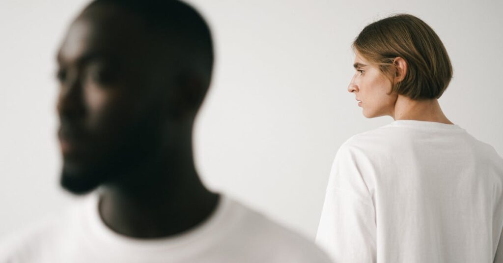 Stylish studio portrait of two models, emphasizing minimalist fashion in white t-shirts.