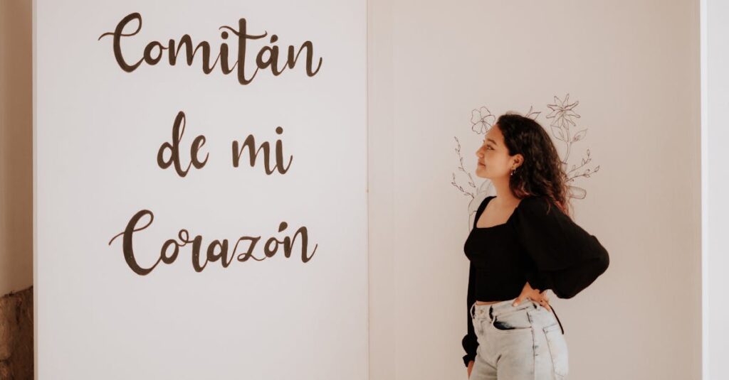 A woman in a black top and denim jeans admires a wall with 'Comitán de mi Corazón' text.