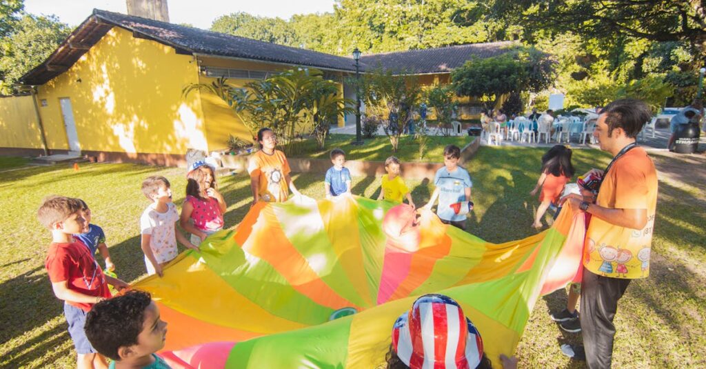 A joyful outdoor birthday party with children playing with a colorful parachute in a garden setting.