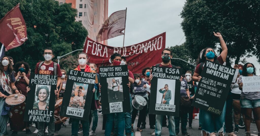 Protest in Rio de Janeiro with people holding banners demanding justice and equality.