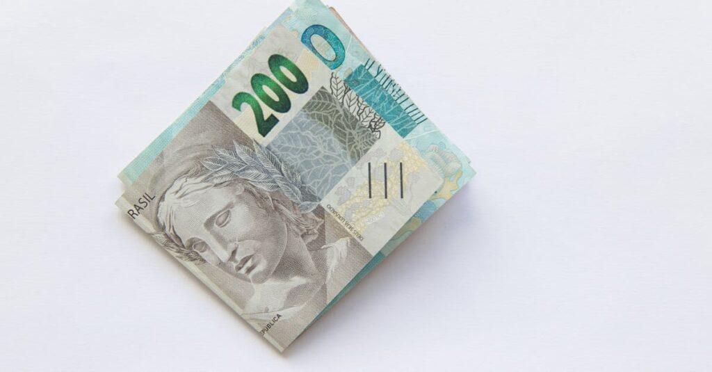 Stack of 200 Brazilian Real banknotes isolated on a white surface, symbolizing wealth and finance.