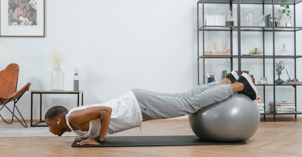 Adult doing push-ups with an exercise ball indoors for fitness and health.