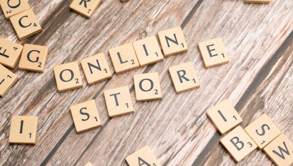 Scrabble tiles spelling 'online store' on a rustic wooden background.