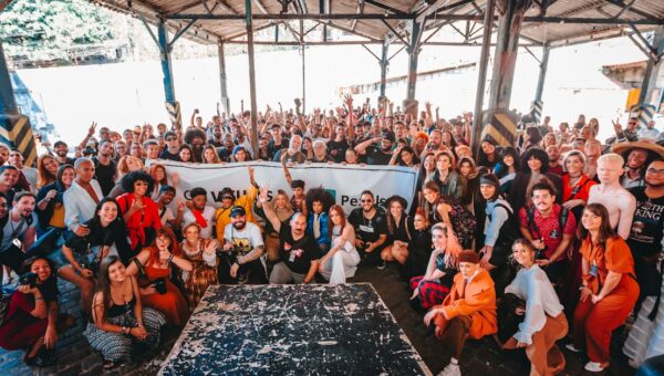 Vibrant group photo in a warehouse in Rio de Janeiro showcasing diversity and togetherness.