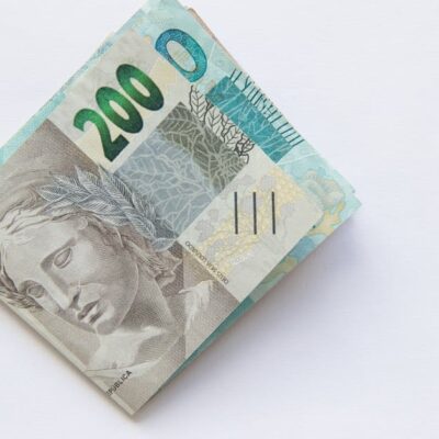 Stack of 200 Brazilian Real banknotes isolated on a white surface, symbolizing wealth and finance.
