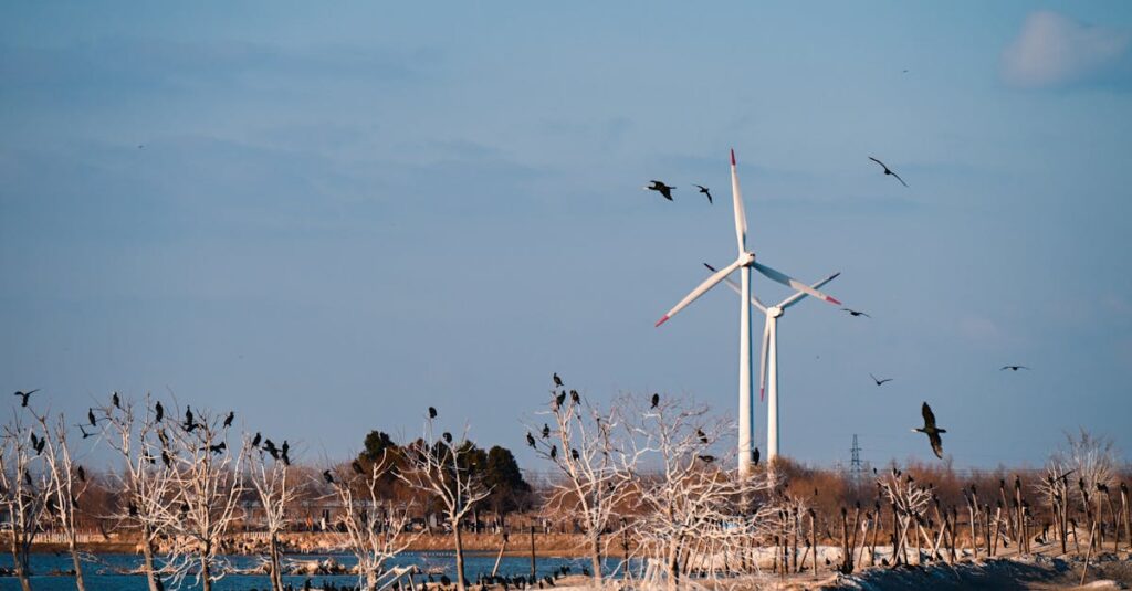 Scenic view of wind turbines with birds perched on trees and flying in a tranquil landscape.
