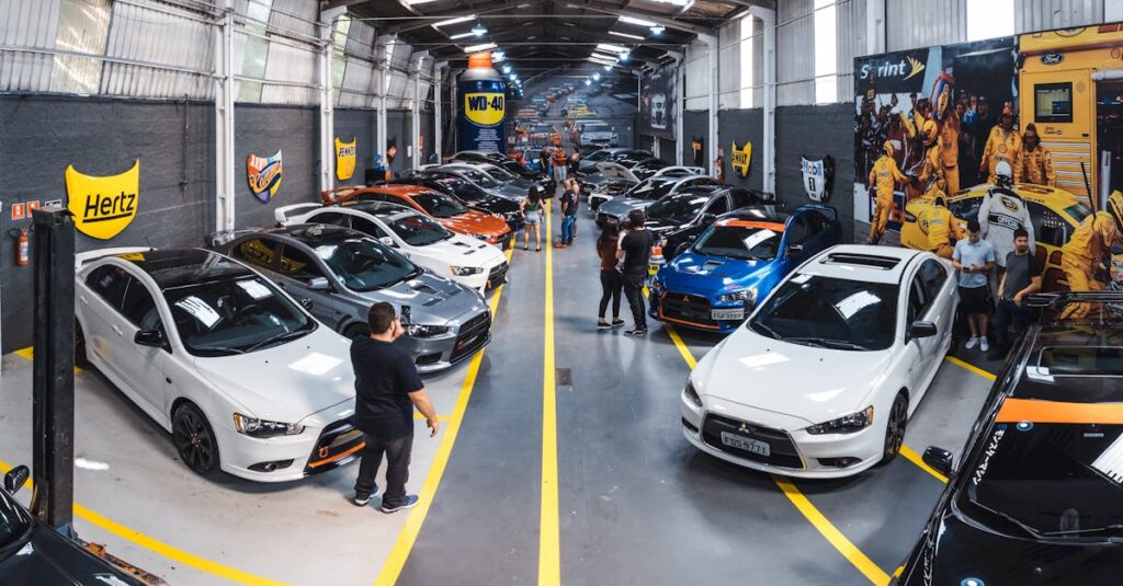 A vibrant scene of a car enthusiast gathering at Vila Nair, showcasing a variety of vehicles indoors.