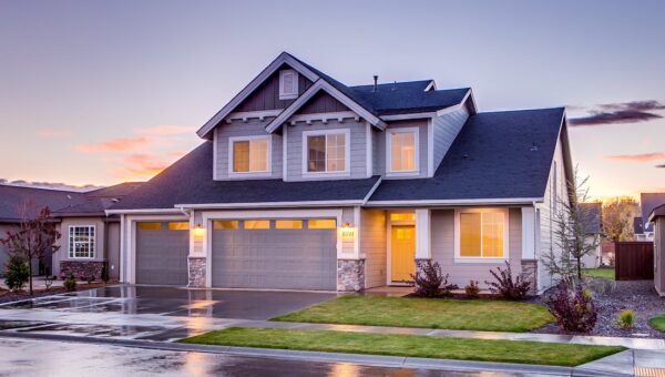 Elegant suburban home with driveway at sunset showcasing modern architecture.