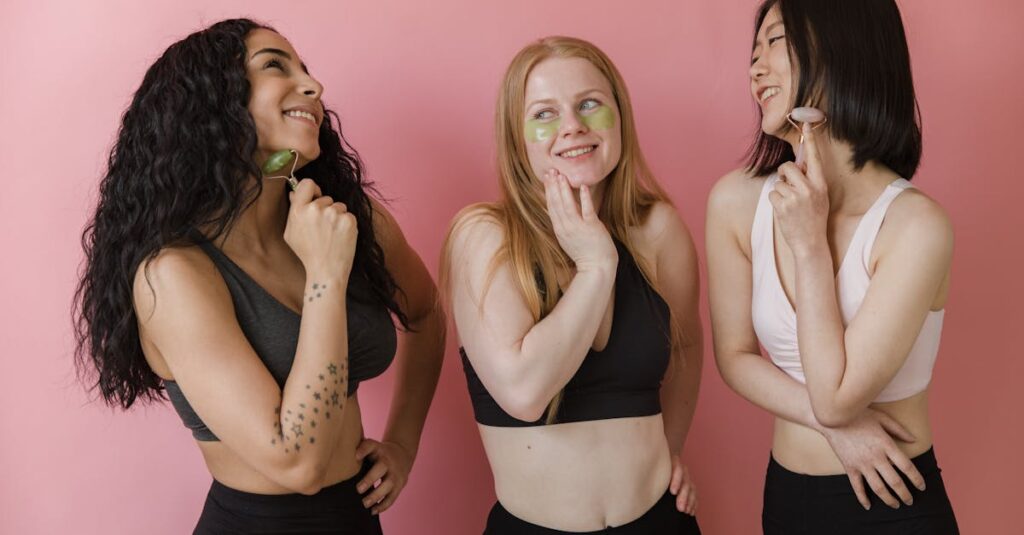 Three diverse women using jade rollers and face masks, enjoying a skincare routine.