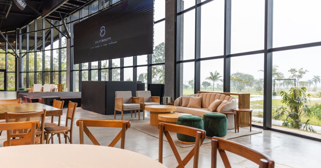 Spacious conference hall featuring modern furniture and large windows with a scenic outdoor view.