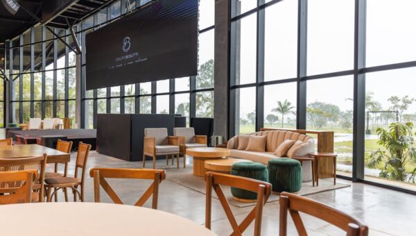 Spacious conference hall featuring modern furniture and large windows with a scenic outdoor view.