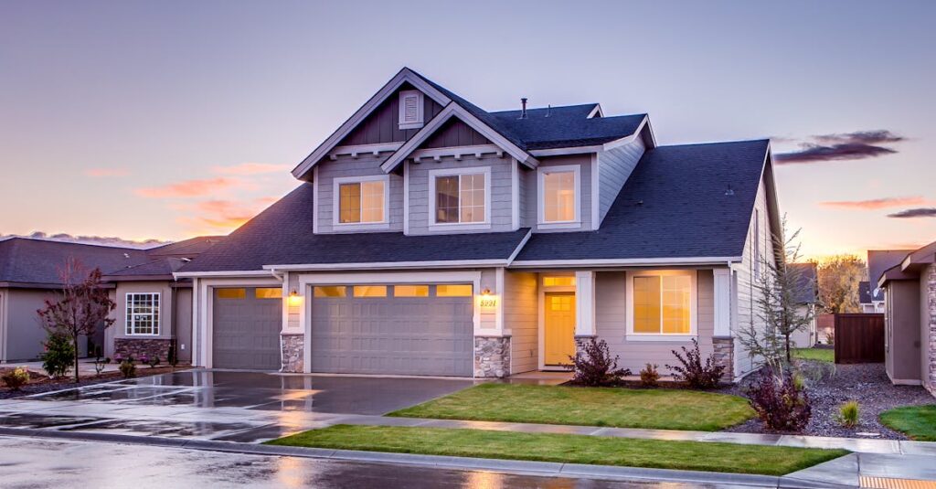 Elegant suburban home with driveway at sunset showcasing modern architecture.