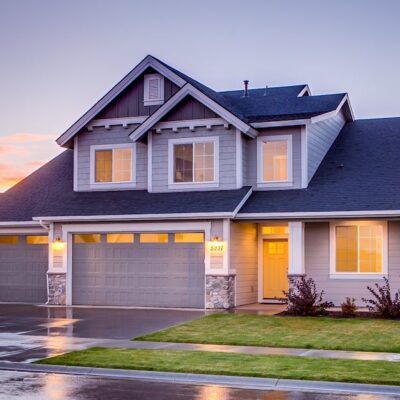 Elegant suburban home with driveway at sunset showcasing modern architecture.