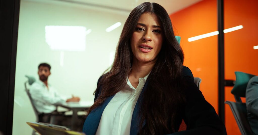 Professional woman in a modern office environment engaging in a business meeting.