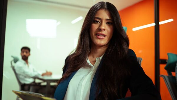 Professional woman in a modern office environment engaging in a business meeting.