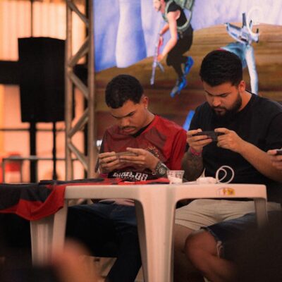Group of gamers intensely focused during a mobile e-sports tournament indoors.