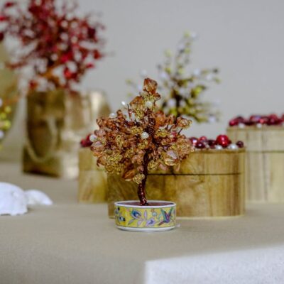 Elegantly crafted beaded tree as part of a decorative table setting.