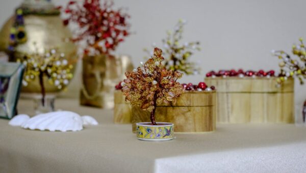 Elegantly crafted beaded tree as part of a decorative table setting.