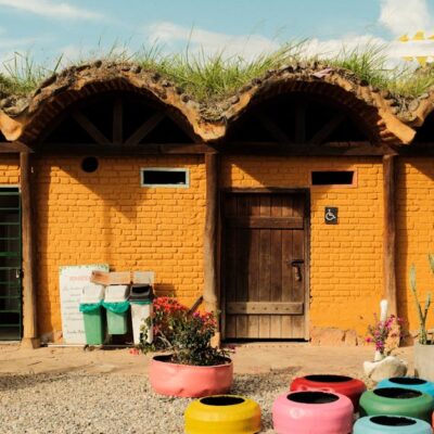 Vibrant outdoor structure with eco-friendly green roof and colorful decorations, showcasing sustainable architecture.