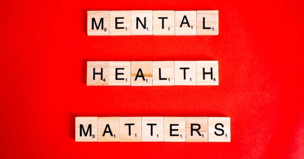 Wooden tiles spelling 'Mental Health Matters' on a vivid red background.