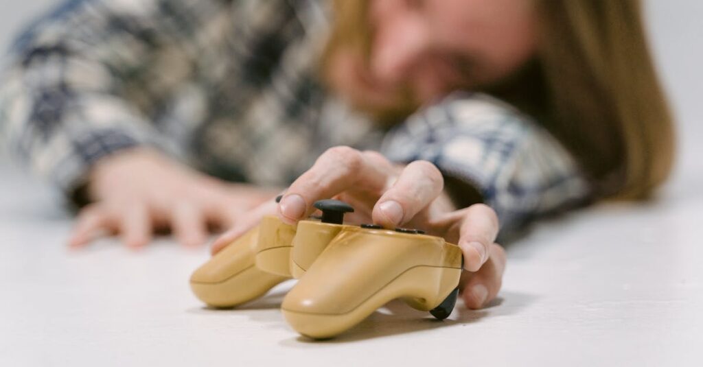 Hand reaching out to touch a yellow game controller, focus on interaction.